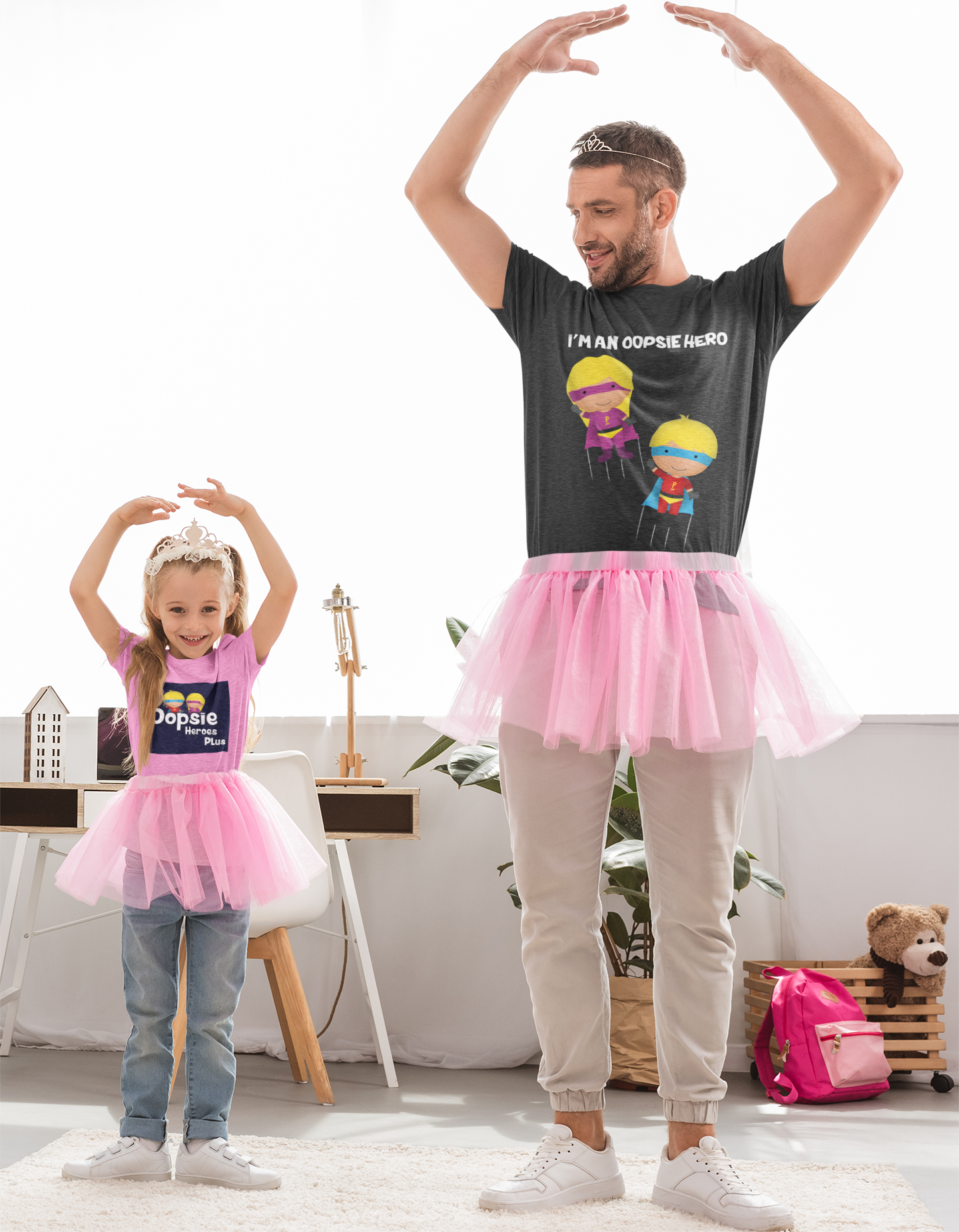Father and daughter dressed in pink tutus and Oopsie Heroes t-shirts